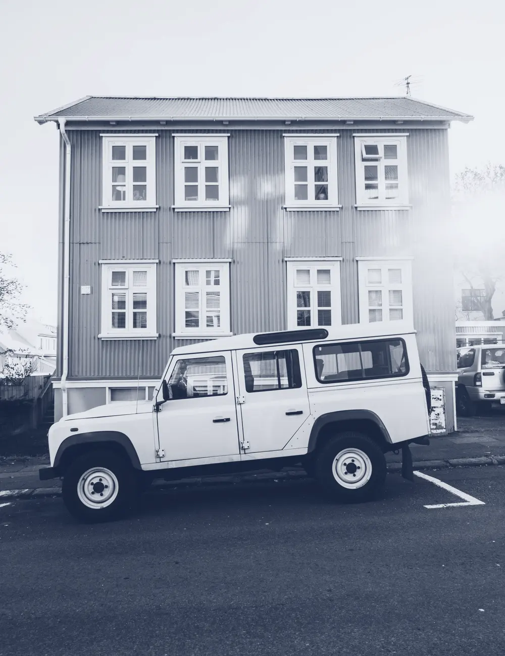 A house with a truck at the curb, in one ink. A placeholder photograph.
